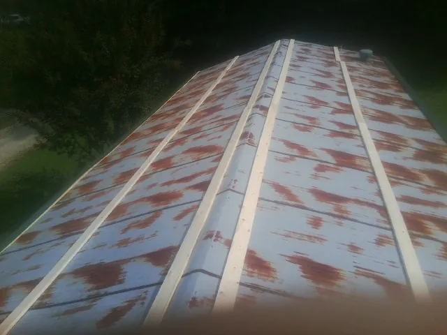 Rusted metal roof panels with new wood purlins before replacement — Storm Damage Roof Repair in Moraga by Roofing Brothers