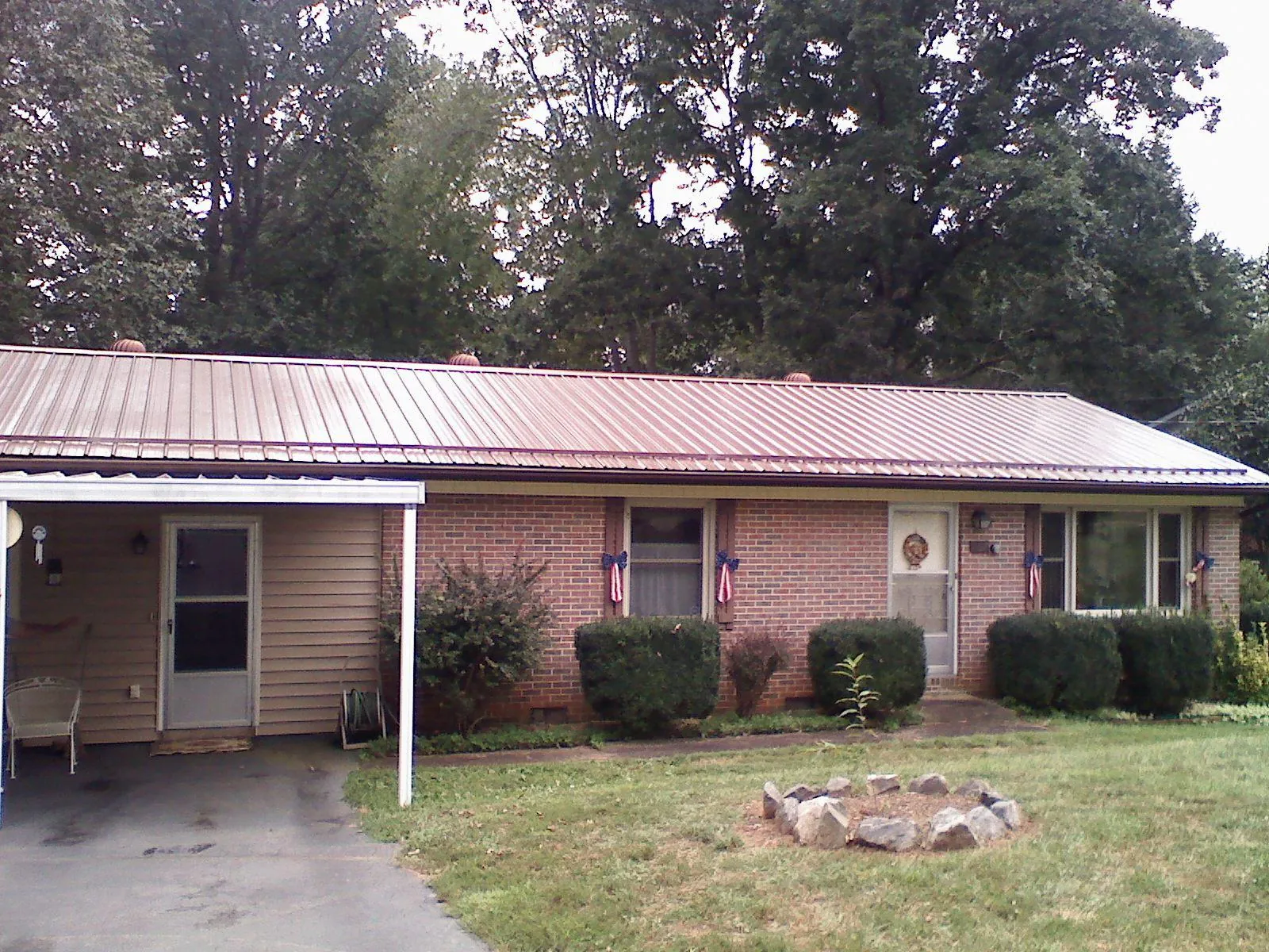 Bronze metal roof and carport on a brick ranch home — Roof Repair work by our crew in Moraga